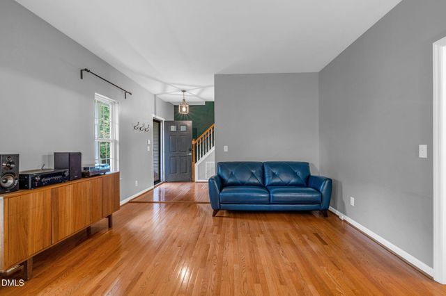 a living room with couch and a wooden floor