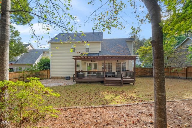 a view of a house with garden and sitting area
