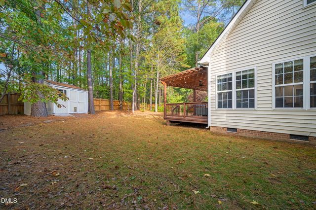 a view of a house with backyard and deck
