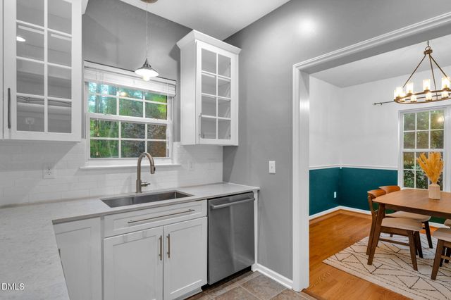 a kitchen with a sink cabinets and window
