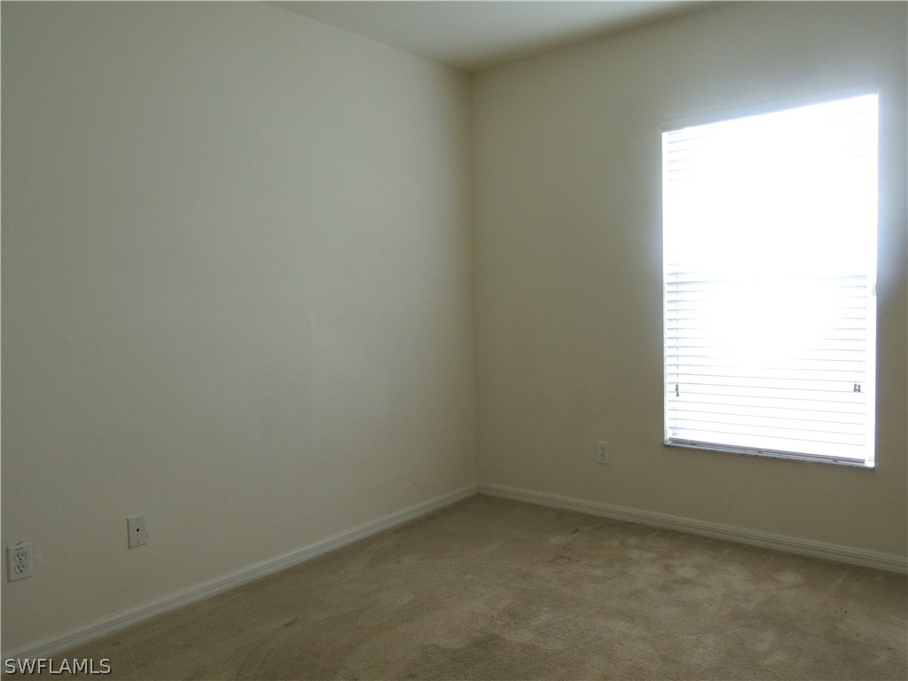 112 Ridgemont Drive Lehigh Acres, FL 33972 - Photo 13 of 18 an empty room with a window