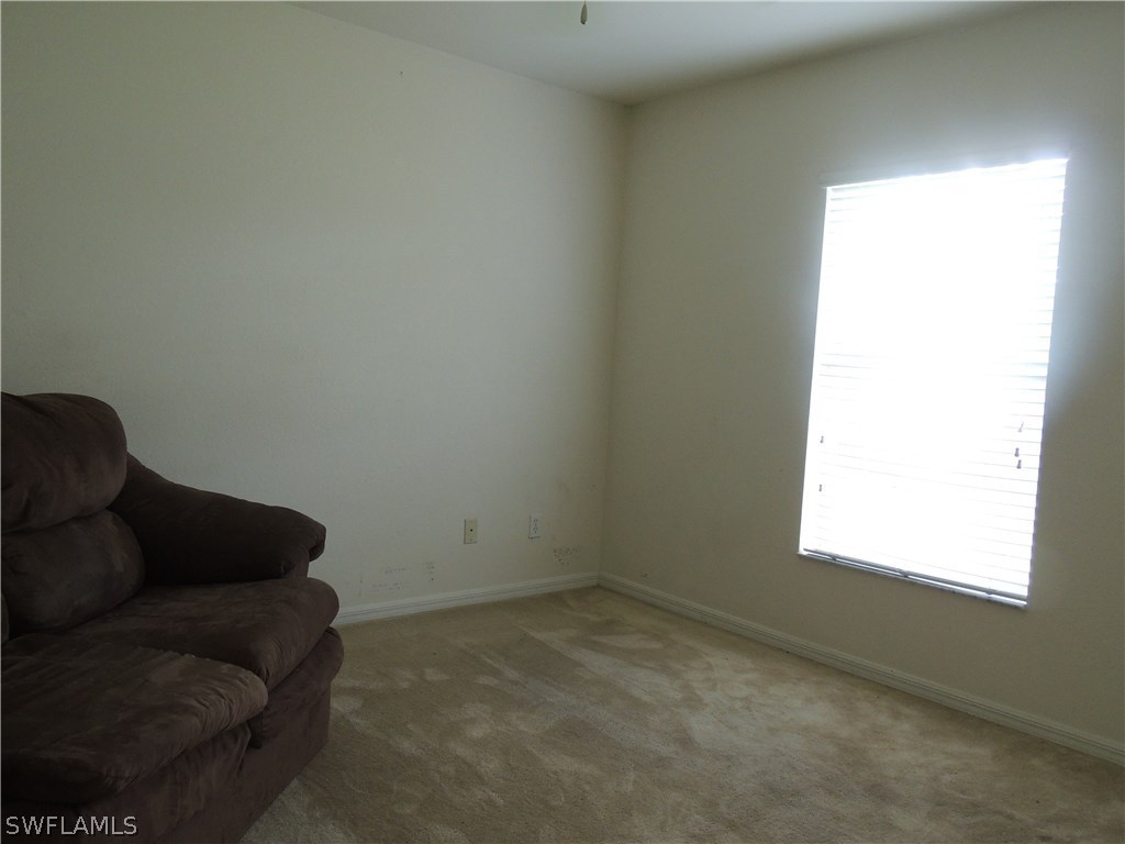 112 Ridgemont Drive Lehigh Acres, FL 33972 - Photo 14 of 18 a living room with furniture and a window