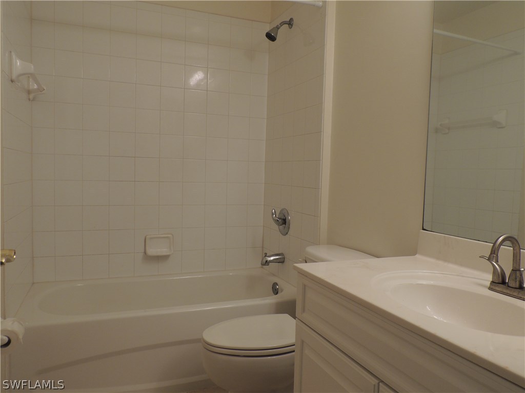 112 Ridgemont Drive Lehigh Acres, FL 33972 - Photo 15 of 18 a bathroom with a granite countertop toilet a sink and bathtub