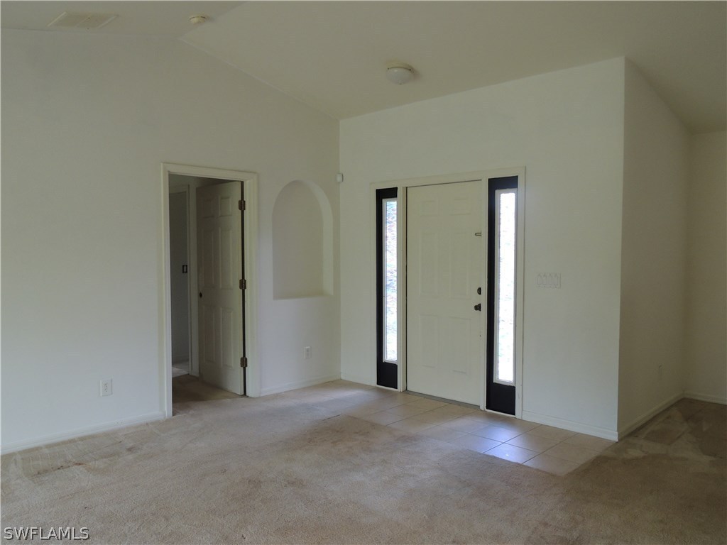 112 Ridgemont Drive Lehigh Acres, FL 33972 - Photo 2 of 18 an empty room with closet and a bathroom