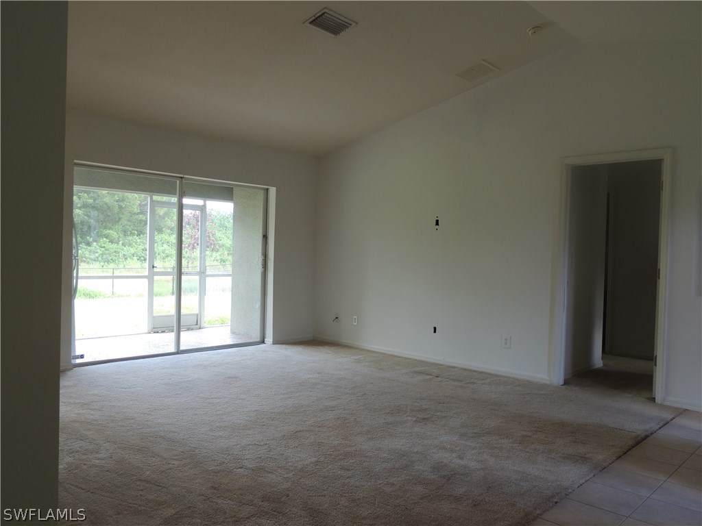 112 Ridgemont Drive Lehigh Acres, FL 33972 - Photo 3 of 18 a view of an empty room with a window