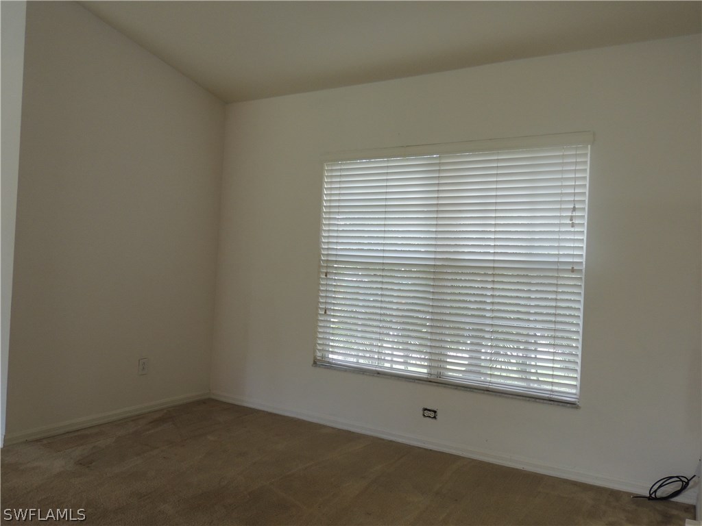 112 Ridgemont Drive Lehigh Acres, FL 33972 - Photo 4 of 18 an empty room with a window