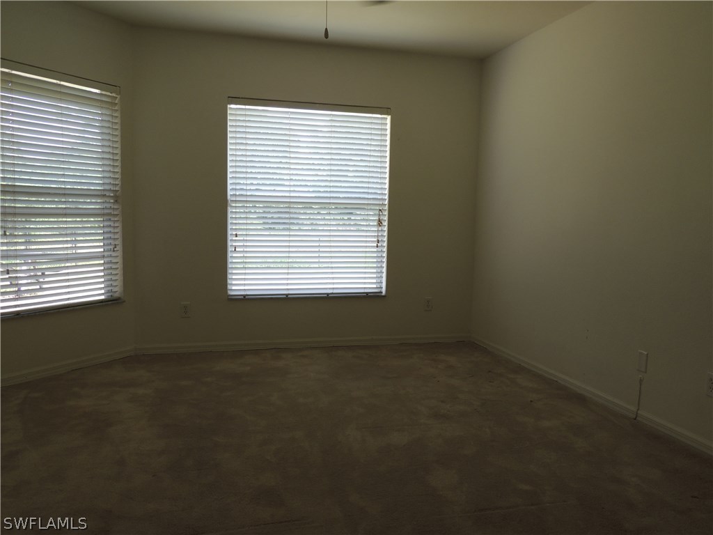 112 Ridgemont Drive Lehigh Acres, FL 33972 - Photo 9 of 18 a view of an empty room with a window