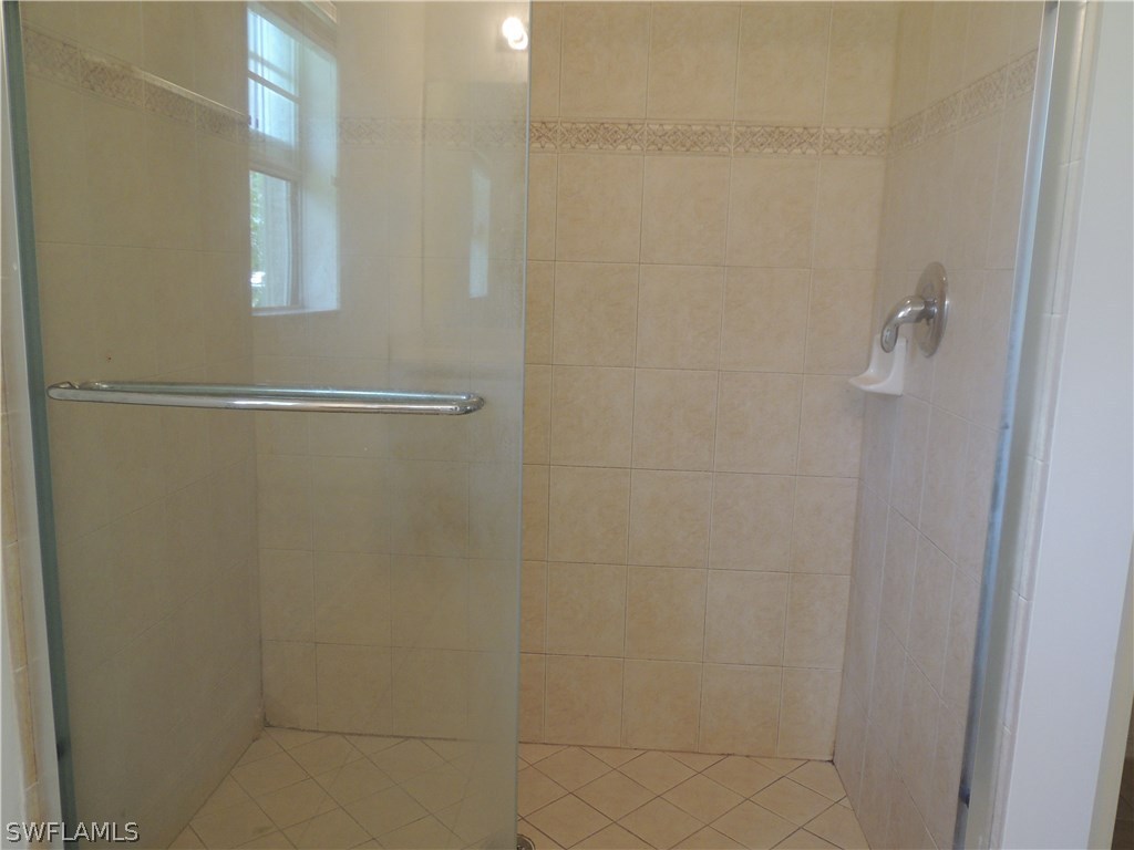 112 Ridgemont Drive Lehigh Acres, FL 33972 - Photo 10 of 18 a bathroom with a shower