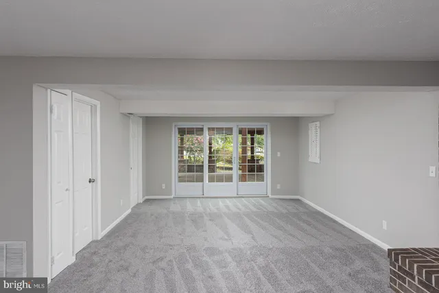 a view of an empty room and wooden floor