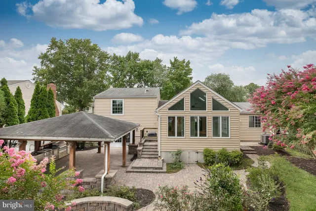 a view of a house with yard and sitting area