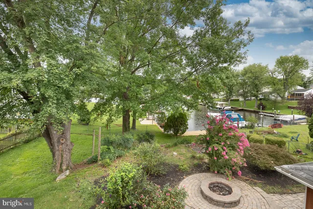 a view of a patio with a table and chairs under an umbrella