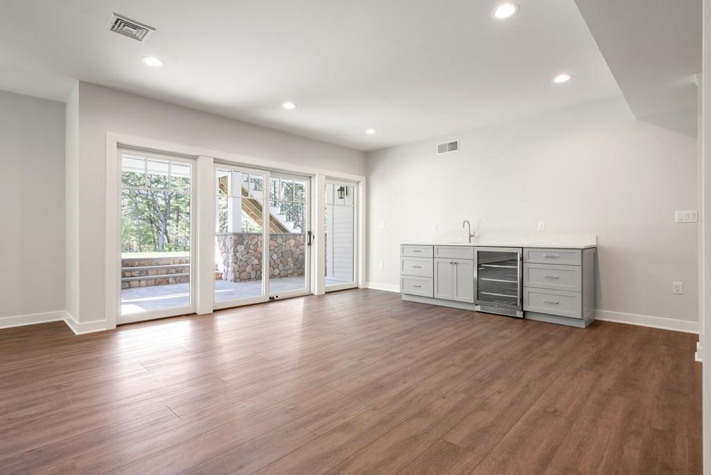 5 Stone Ridge Lane Weston, MA 02493 - Photo 29 of 40 a view of an empty room with wooden floor and a window
