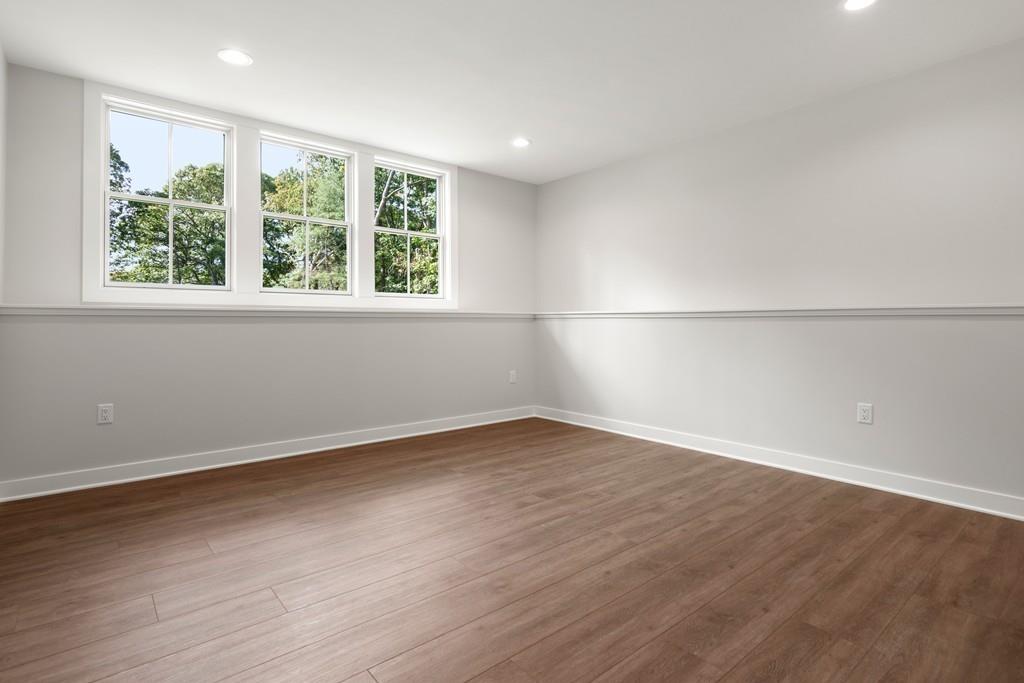 5 Stone Ridge Lane Weston, MA 02493 - Photo 30 of 40 an empty room with wooden floor and window