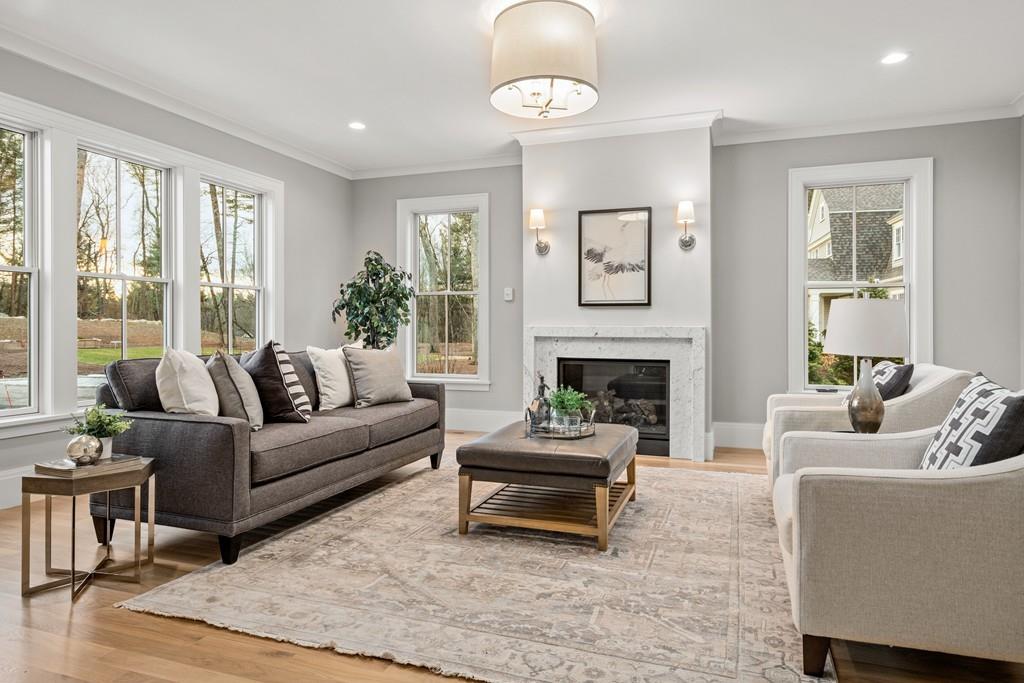 5 Stone Ridge Lane Weston, MA 02493 - Photo 3 of 40 a living room with furniture a fireplace and a table