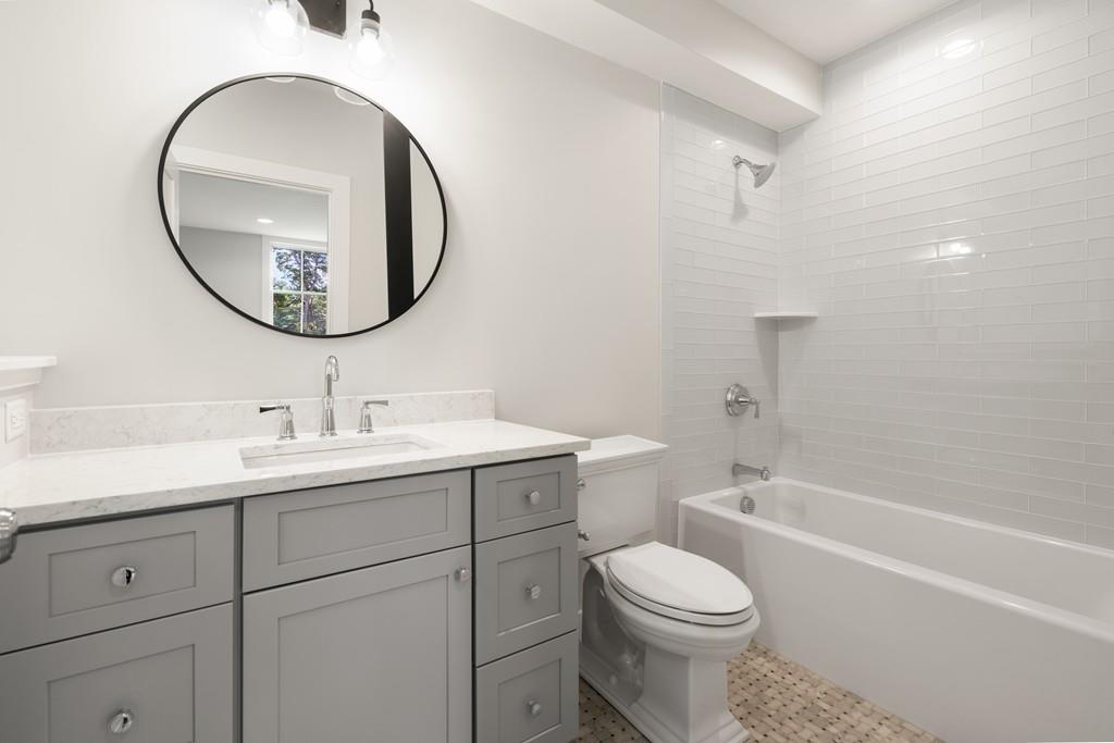 5 Stone Ridge Lane Weston, MA 02493 - Photo 31 of 40 a bathroom with a toilet sink and mirror