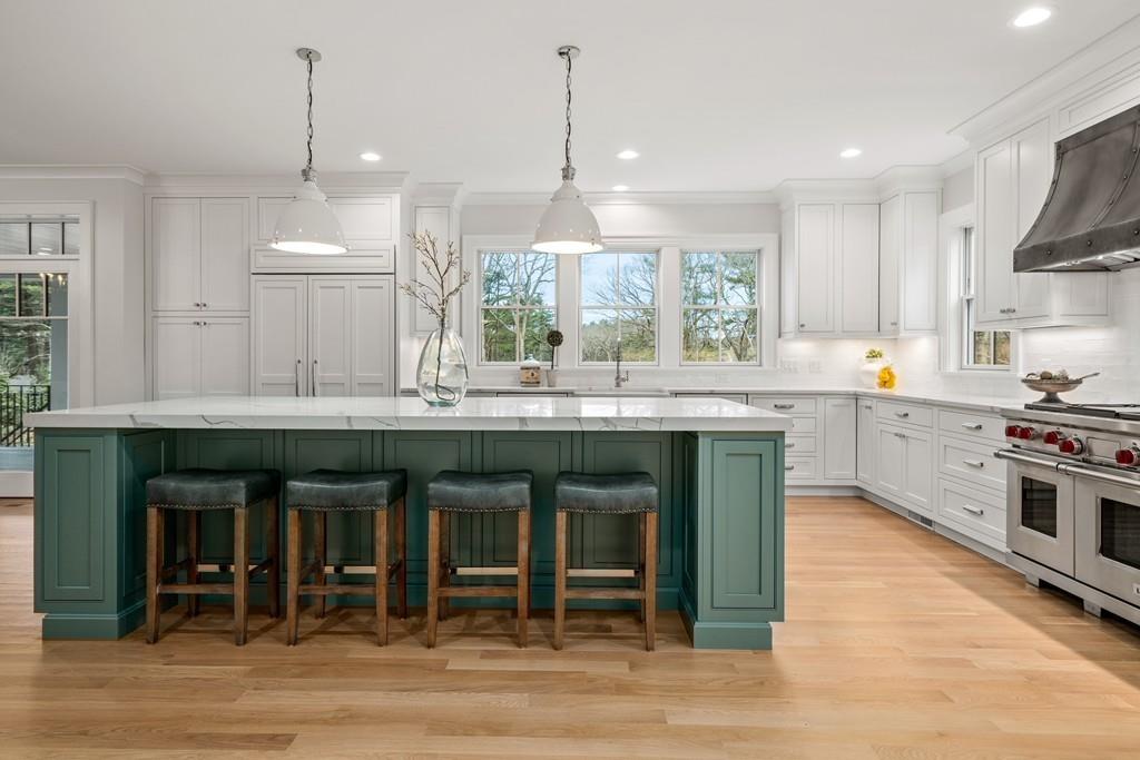 5 Stone Ridge Lane Weston, MA 02493 - Photo 7 of 40 a kitchen with kitchen island granite countertop a stove a sink and a wooden floors