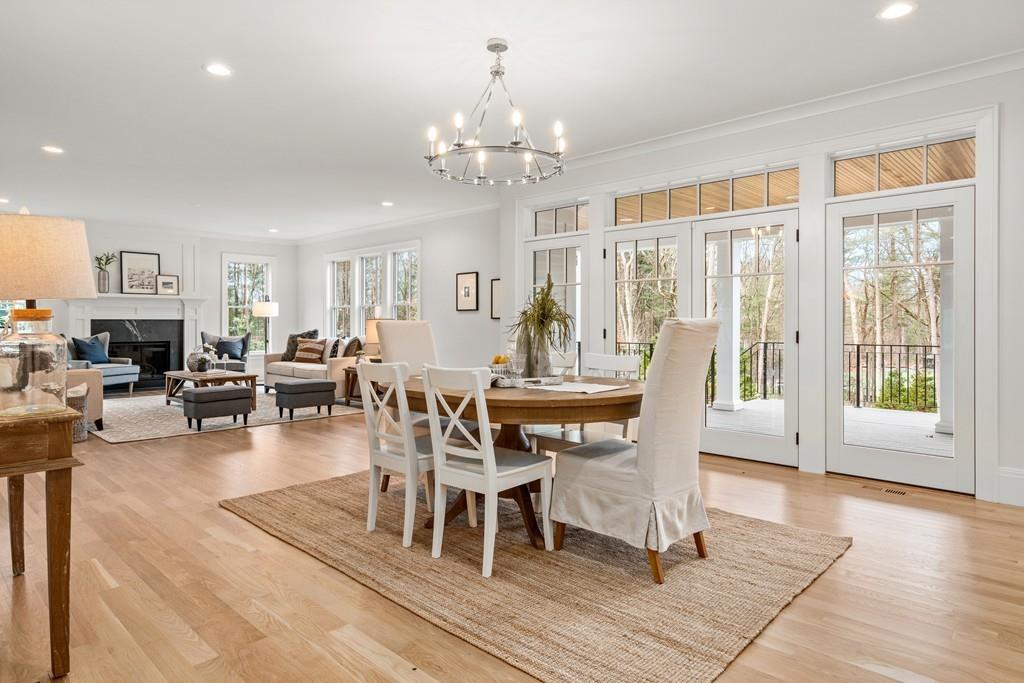 5 Stone Ridge Lane Weston, MA 02493 - Photo 8 of 40 a dining room with wooden floor a chandelier a wooden table and chairs
