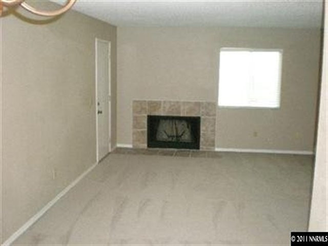 2080 Highview Court, Unit 5 Reno, NV 89512 - Photo 3 of 9 a view of an empty room with a fireplace and a window