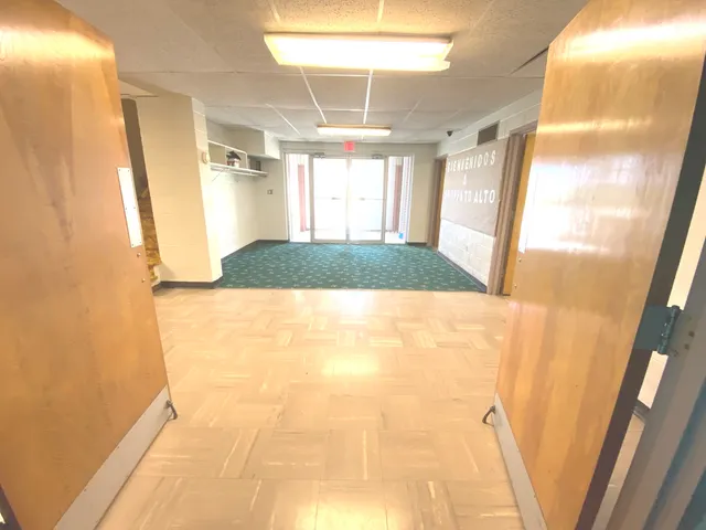 a view of a room with a large window and floor to ceiling window