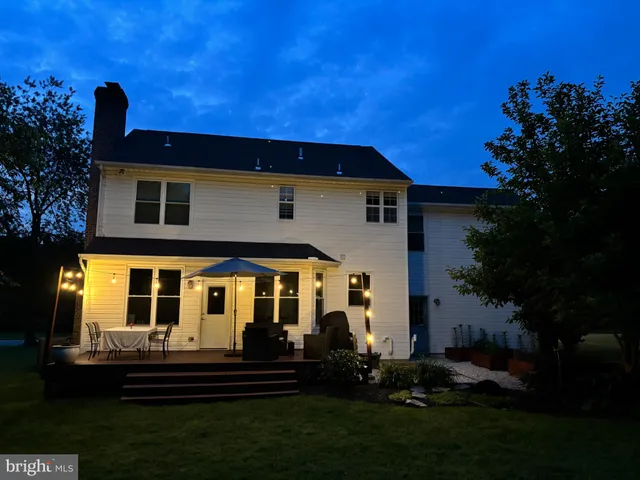 a view of a house with a yard porch and sitting area