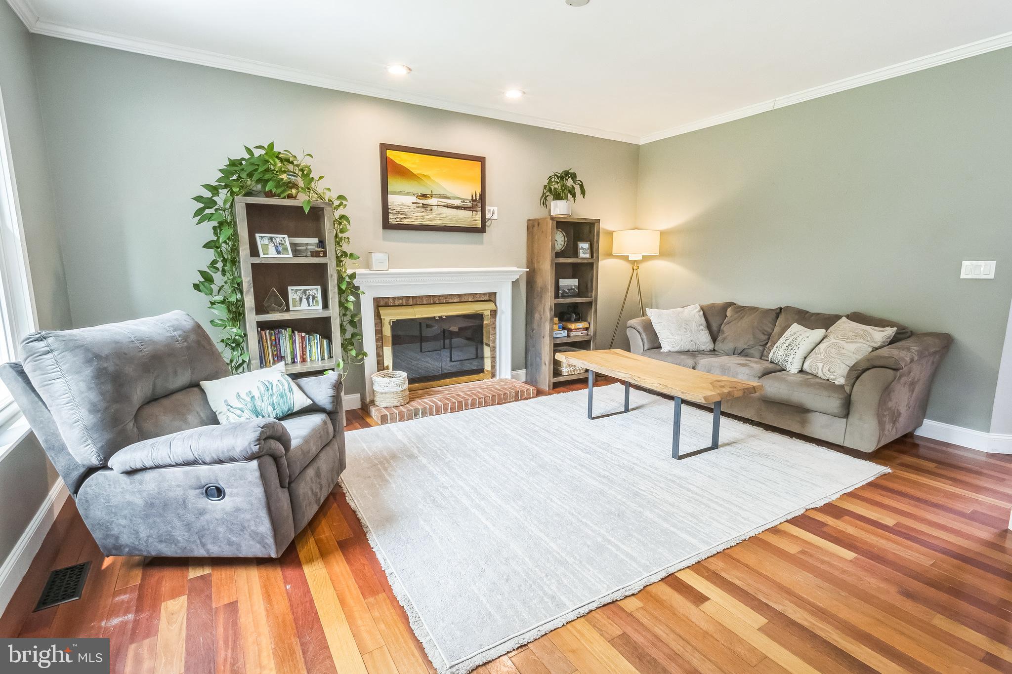 26 Emerald Ridge Drive Bear, DE 19701 - Photo 3 of 35 Cozy living room with wood flooring and fireplace