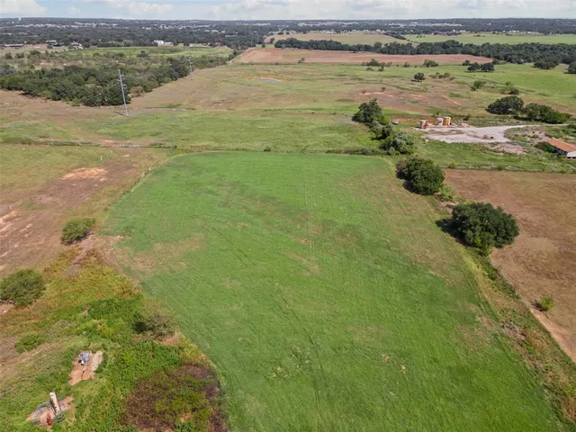 an aerial view of a houses with a yard