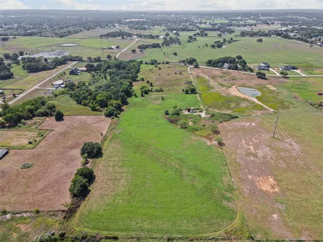 an aerial view of a houses with a yard