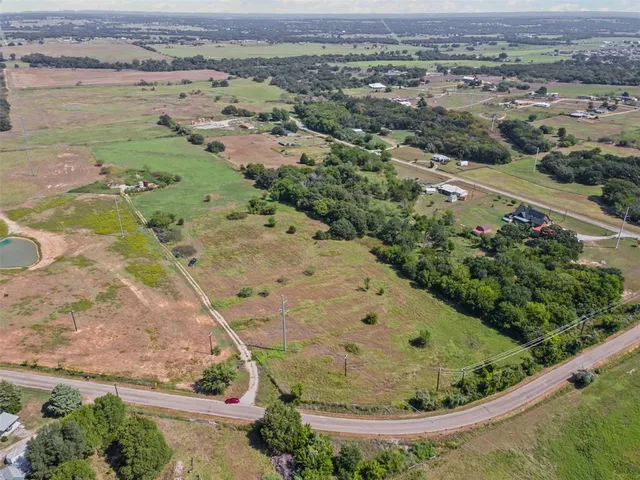 an aerial view of a house with a field