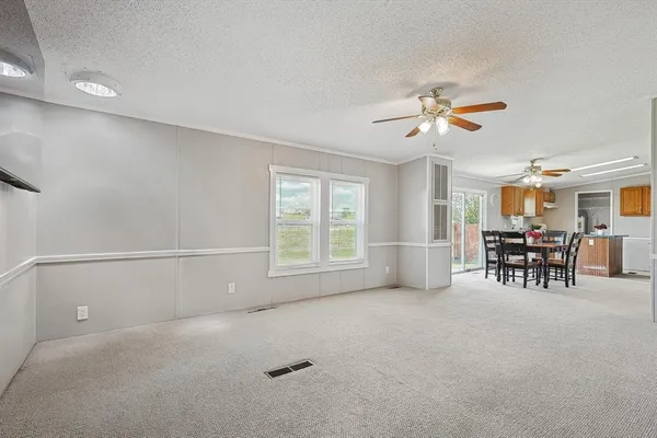 a view of a livingroom with furniture and ceiling fan