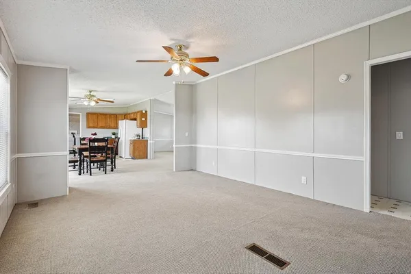 a view of a livingroom with a furniture and chandelier fan