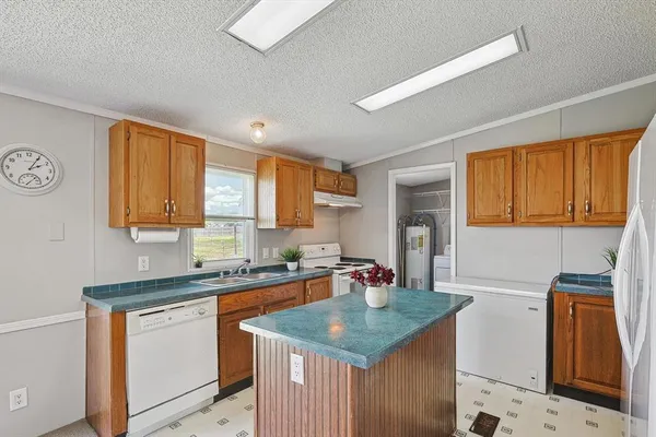 a kitchen with stainless steel appliances granite countertop a sink stove and cabinets