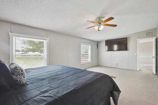 a bedroom with a large bed and a window