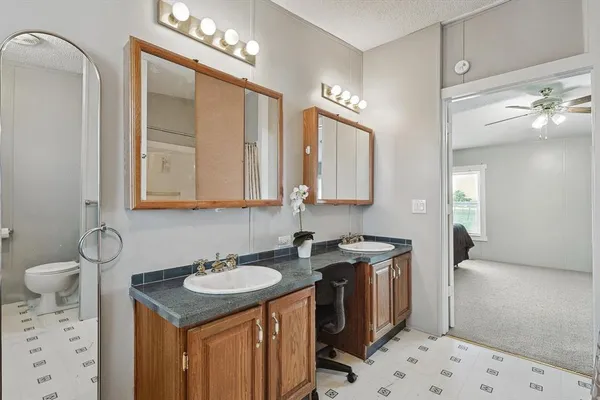 a bathroom with a sink a vanity and a mirror