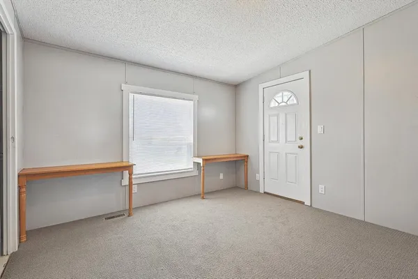 a spacious bedroom with a bathtub and a window