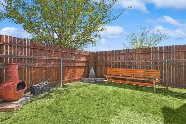 a view of a backyard with wooden fence