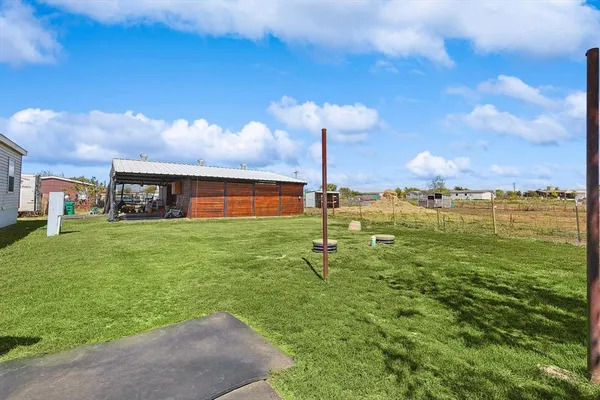 a swimming pool with yard in front of it