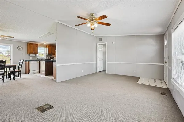 a view of a livingroom with furniture and ceiling fan