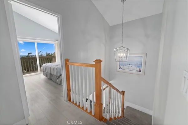 a view of staircase with railing and white walls