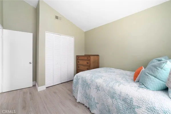 a bedroom with a bed and a closet