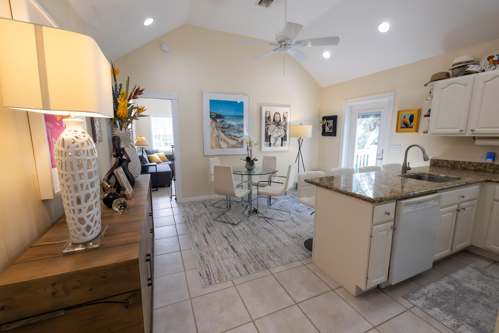 1012 Packer Street, Unit 7A Key West, FL 33040 - Photo 6 of 20 a kitchen with stainless steel appliances granite countertop a sink dishwasher stove top oven and cabinets