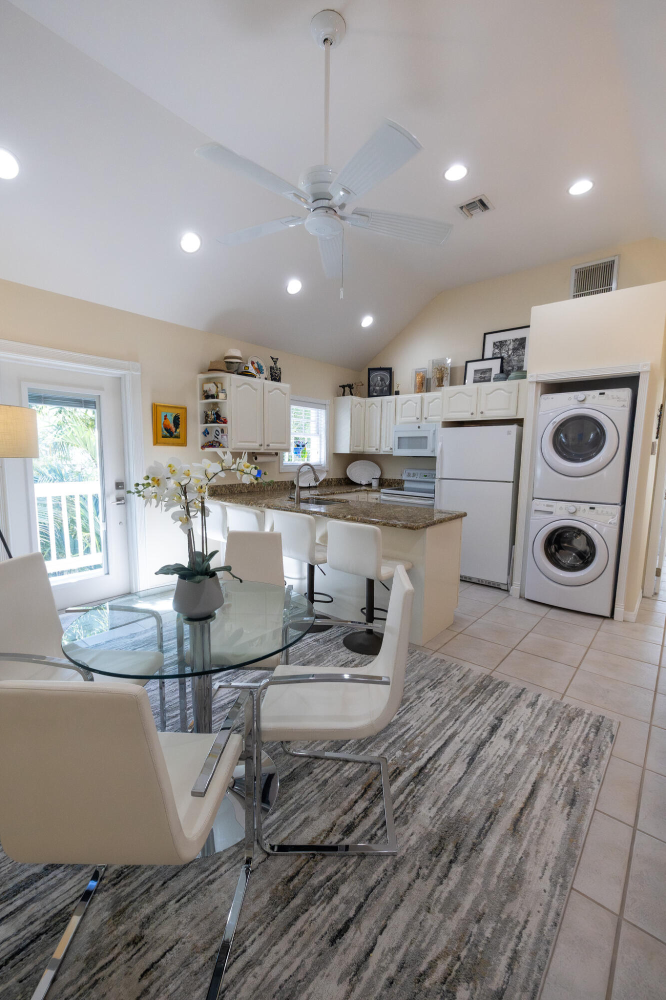 1012 Packer Street, Unit 7A Key West, FL 33040 - Photo 8 of 20 a kitchen with kitchen island granite countertop a sink cabinets and stainless steel appliances