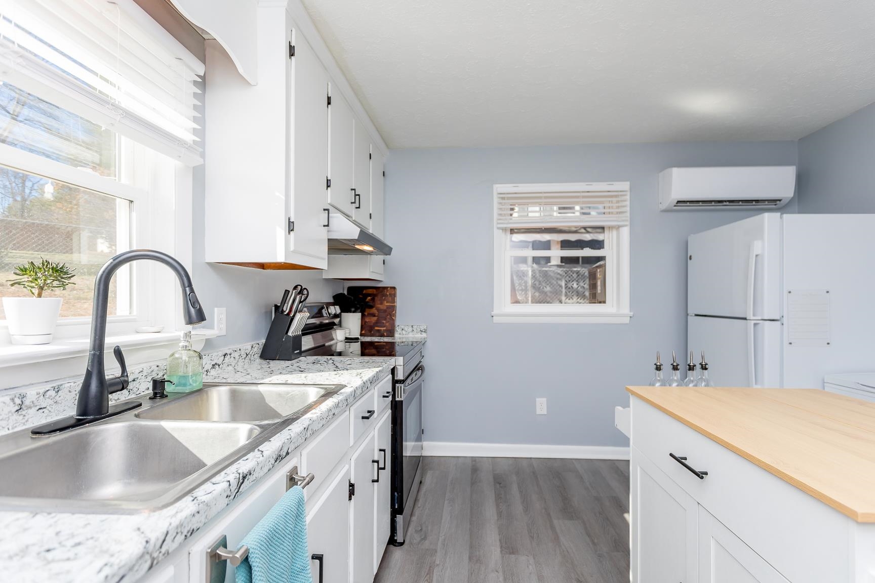 170 Quick's Mill Road Verona, VA 24482 - Photo 15 of 45 a kitchen with granite countertop a sink a stove and cabinets