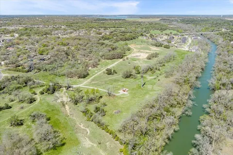 a view of a lake with green field