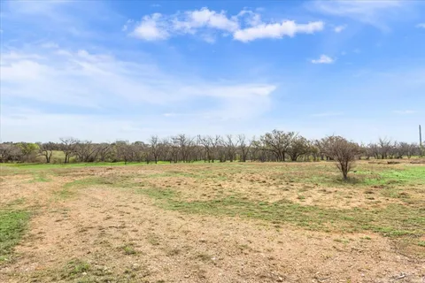 a view of a balcony with a yard