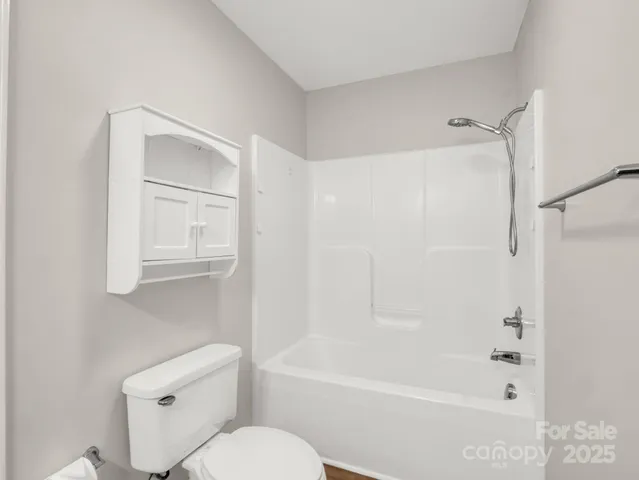 a bathroom with a toilet and a bathtub