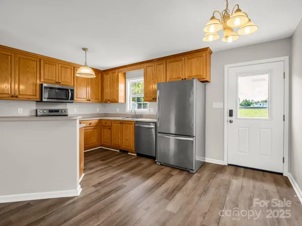 a kitchen with a refrigerator a stove a microwave and cabinets