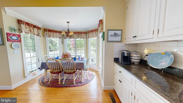 a bathroom with a granite countertop toilet sink and mirror