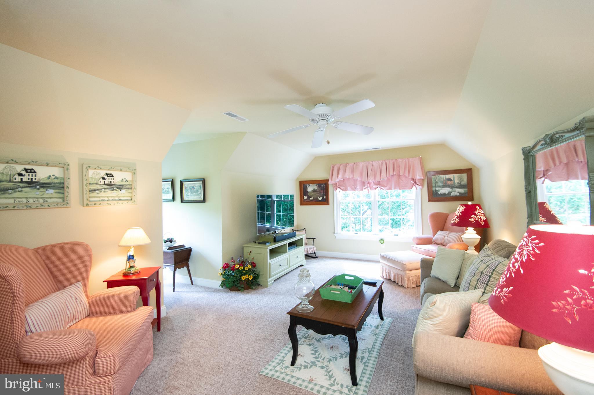 28028 Playtor Road Easton, MD 21601 - Photo 49 of 80 a living room with furniture a window and a flat screen tv