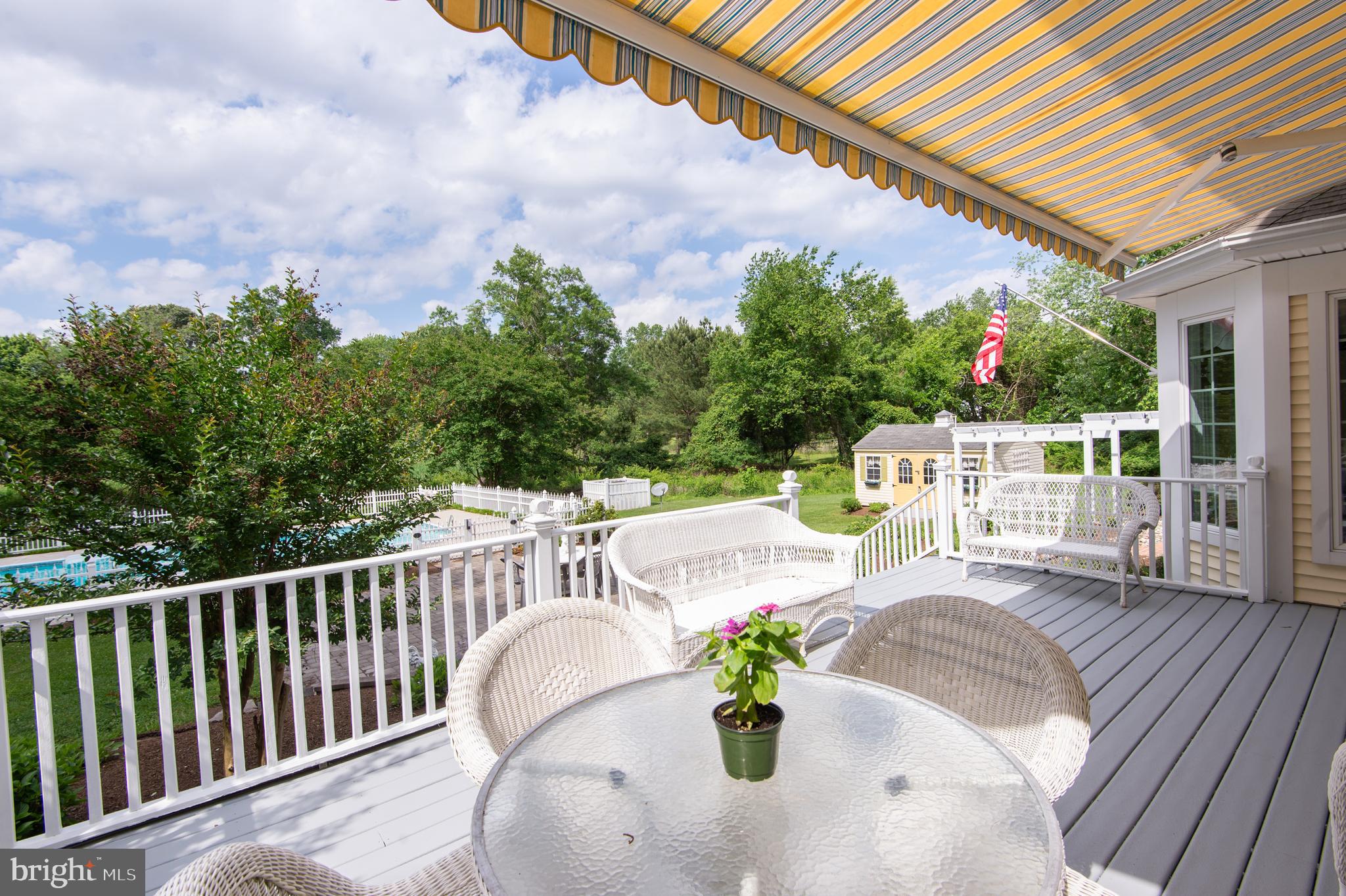 28028 Playtor Road Easton, MD 21601 - Photo 63 of 80 a view of a patio with a table chairs and a wooden fence