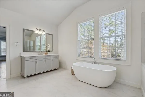a bathroom with a tub and shower